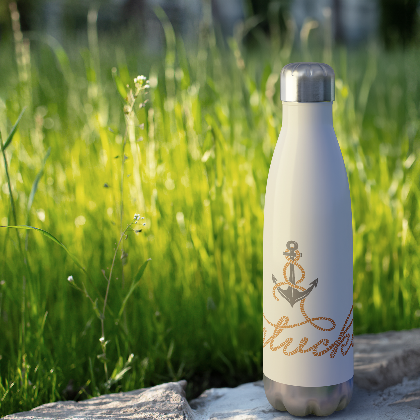 Anchored_in_Nantucket_Water_Bottle_WaterBottle_Outdoor_grass_Mockup.png
