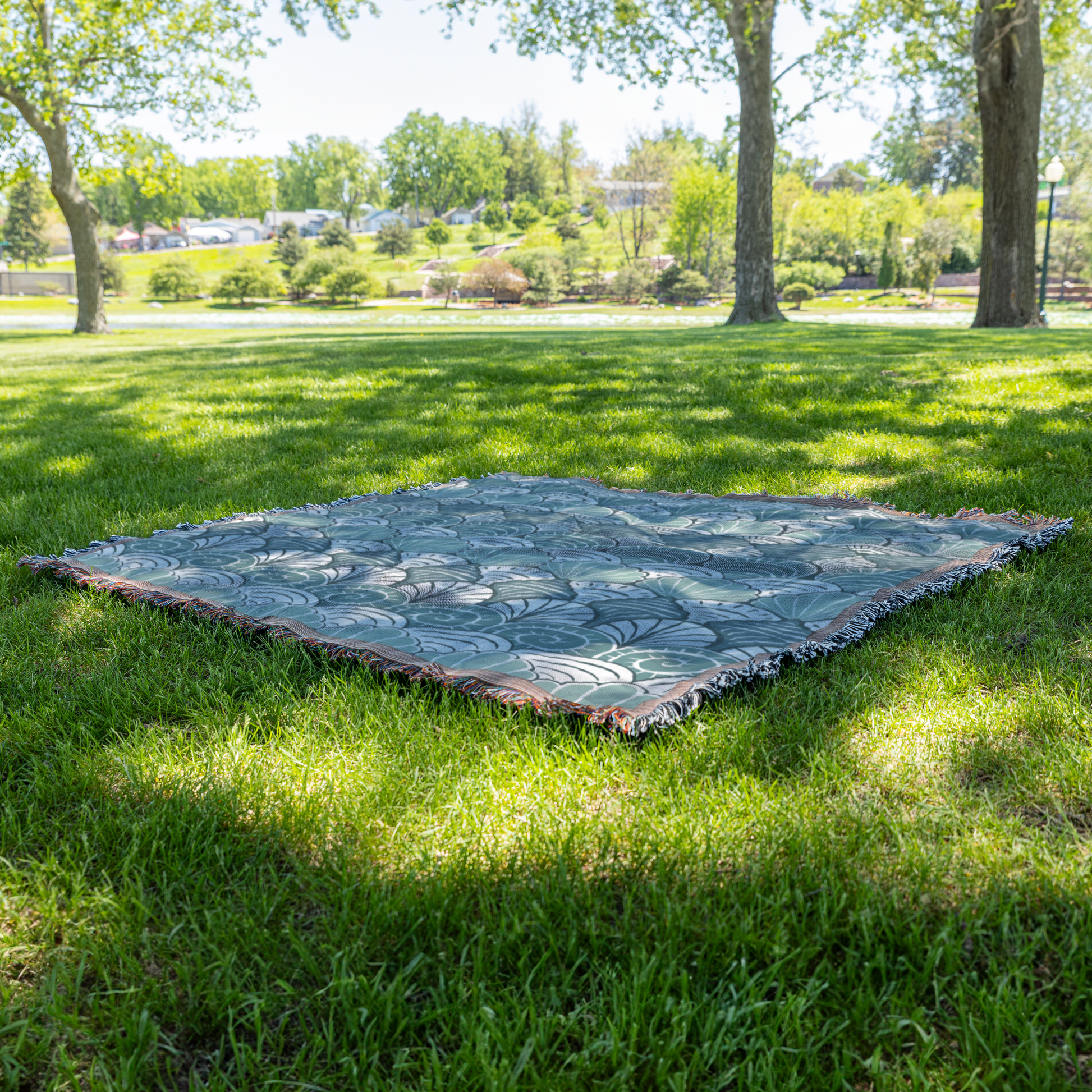 Blue_Seashell_Pattern_Woven_Blanket_Grass_V_Mockup.png